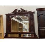 An Art Nouveau mahogany overmantle mirror with carved acanthus leaf and classical urn decoration,
