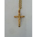 A cased 9ct gold crucifix on a 9ct gold chain, approx. 6g.