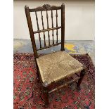 An 18th Century ash and elm rush seated spindle back country dining chair.