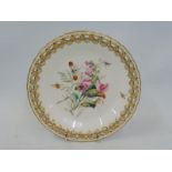 A Royal Worcester cabinet plate with a pierced gilded border and central hand painted floral