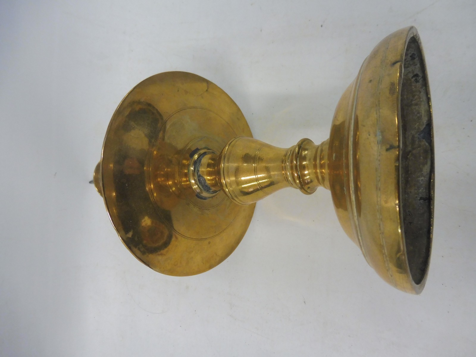 A 17th Century Dutch West Indies brass pricket candlestick with a broad mid drip pan, 11" long. - Image 4 of 5