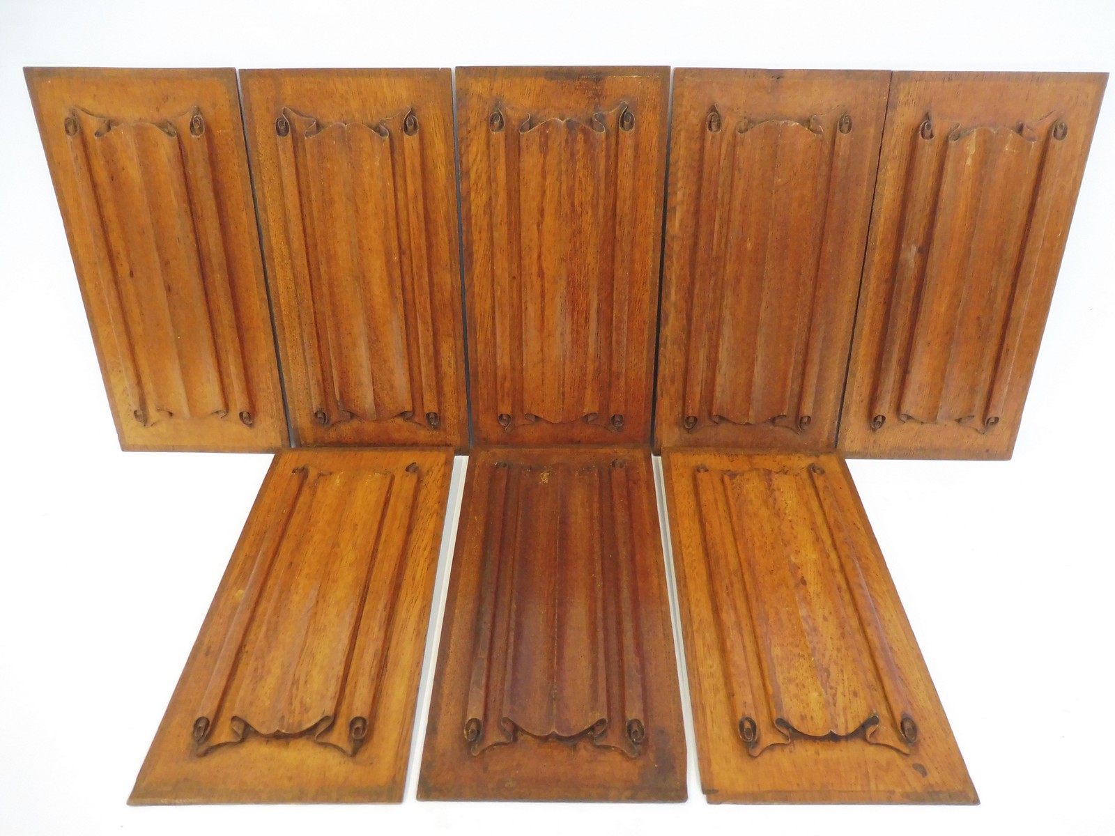 A set of eight 19th Century decorative carved oak linen fold panels, each 8 1/4 x 16 3/4".