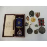A small group of badges and medals, some enamel including a silver National Fire Brigade Association