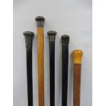 Four silver mounted walking canes and one other.