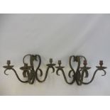 A pair of three branch wrought iron wall lights.