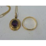 A 9ct gold wedding band and a 9ct gold pendant on chain set with a central amethyst, approx. 5g.
