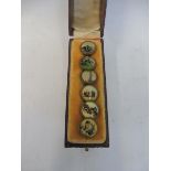 A cased set of six buttons, each depicting a different scene including a Veteran motor car, sailing,