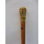 A malacca walking cane with a steel inlaid ivory knop.