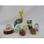 A selection of glass paperweights plus two glass animal ornaments.