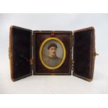 A leather cased oval portrait miniature of a lady.