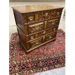 An 18th Century oak chest of four long drawers, with geometric moulded drawers and panelled sides,