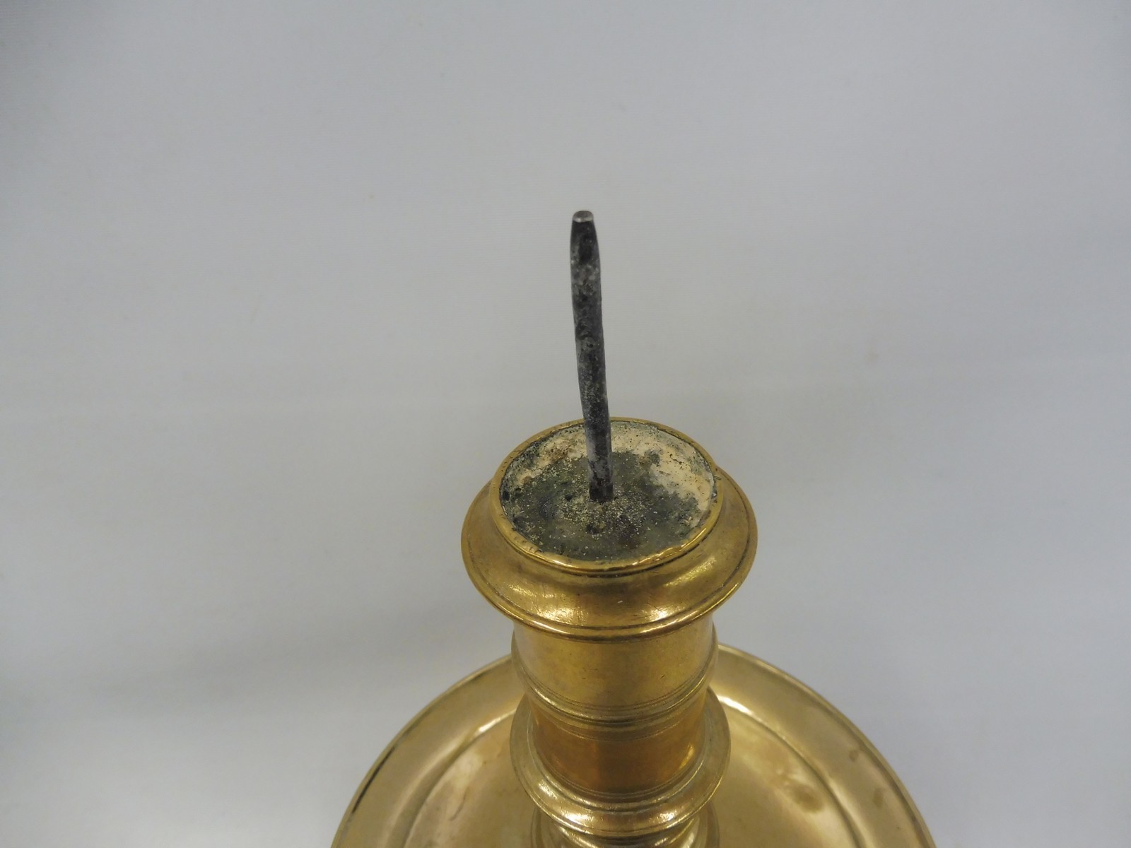 A 17th Century Dutch West Indies brass pricket candlestick with a broad mid drip pan, 11" long. - Image 2 of 5