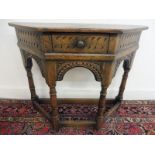 An Ipswich style oak tri-sided carved single drawer side table of good colour, 53 1/2" w x 28" h x