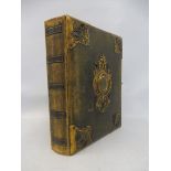 A good quality late Victorian leather photograph album with gilded brass and black enamel mounts,