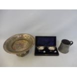 A white metal tazza, a cased pair of silver plated salts and an unusual pewter tankard, bearing