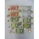 A selection of £5 and £1 bank notes, a £5 coin, eight £2 coins and two 50 pence pieces.