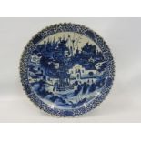 An 18th Century Chinese circular charger with a busy town scene, with figures and animals, set