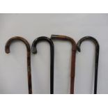 Four assorted silver mounted walking sticks.