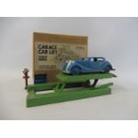 A boxed early Crescent garage car and lift, set appears complete (bar figure) including oil pump and