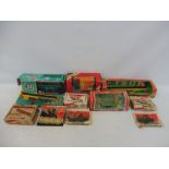 An assortment of Britains farm accessories from different eras, boxes in various conditions.