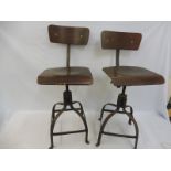 A pair of original circa 1950s industrial workshop chairs, swivel mechanism to adjust height,