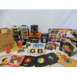 A collection of assorted tins, ephemera, 45s and various plastic utensils etc.