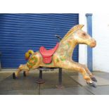 A superbly original galloping horse in original paint, circa 1950s, remains of gold leaf paint.