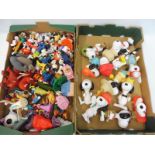 Two boxes of figures, to include a large number of Snoopy.