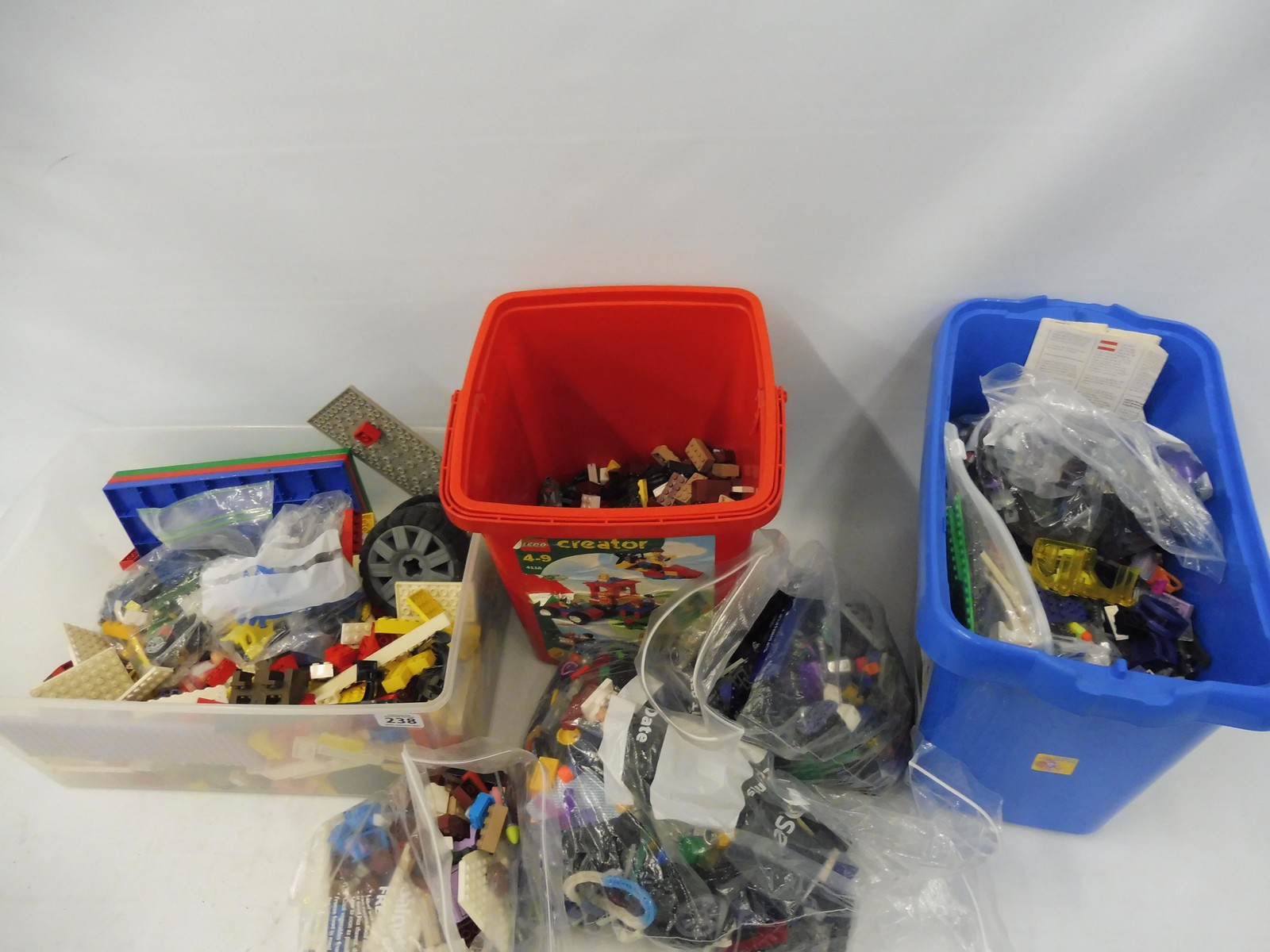 A quantity of unchecked Lego and Megablocks in three boxes.