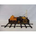 A Mamod live steam Stephenson's Rocket, in playworn condition, with a small amount of track.