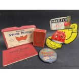 A Hartley's Jelly fridge magnet, a Lott's stone puzzel, a pack of dominoes cards and a McFarlane