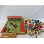 A collection of agricultural vehicles, farm animals and buildings.
