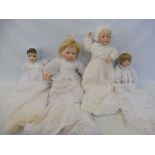 Four contemporary porcelain headed dolls.