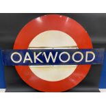 A London Underground railway station enamel sign for Oakwood, 52 1/2 x 40 3/4".