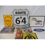 A collection of reproduction signs, including Ford, AA, Ferrari, Shell etc.