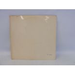 An original toploader Beatles White Album together with four photographs, no. 0212775, condition