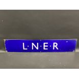 An L.N.E.R. railway dark blue enamel sign in excellent condition, 28 1/2 x 5 3/4".