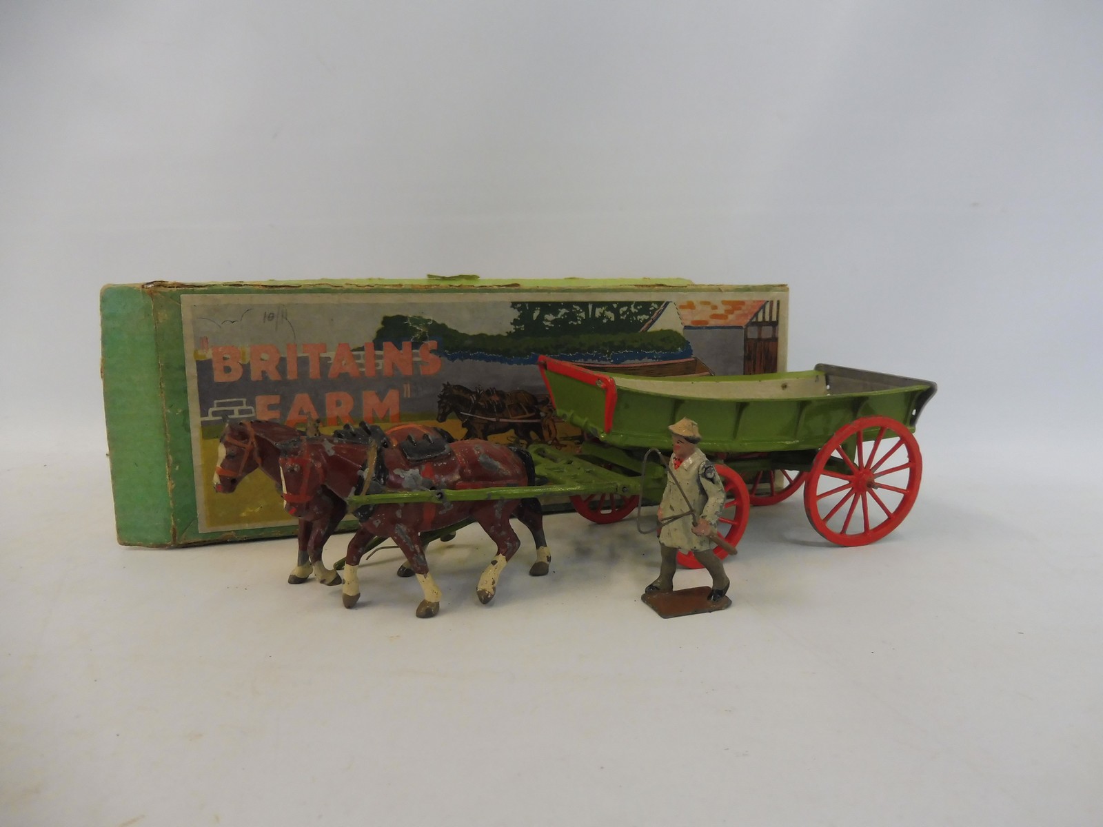 An early Britains farm wagon, box no 5F, in playworn condition but appears complete.