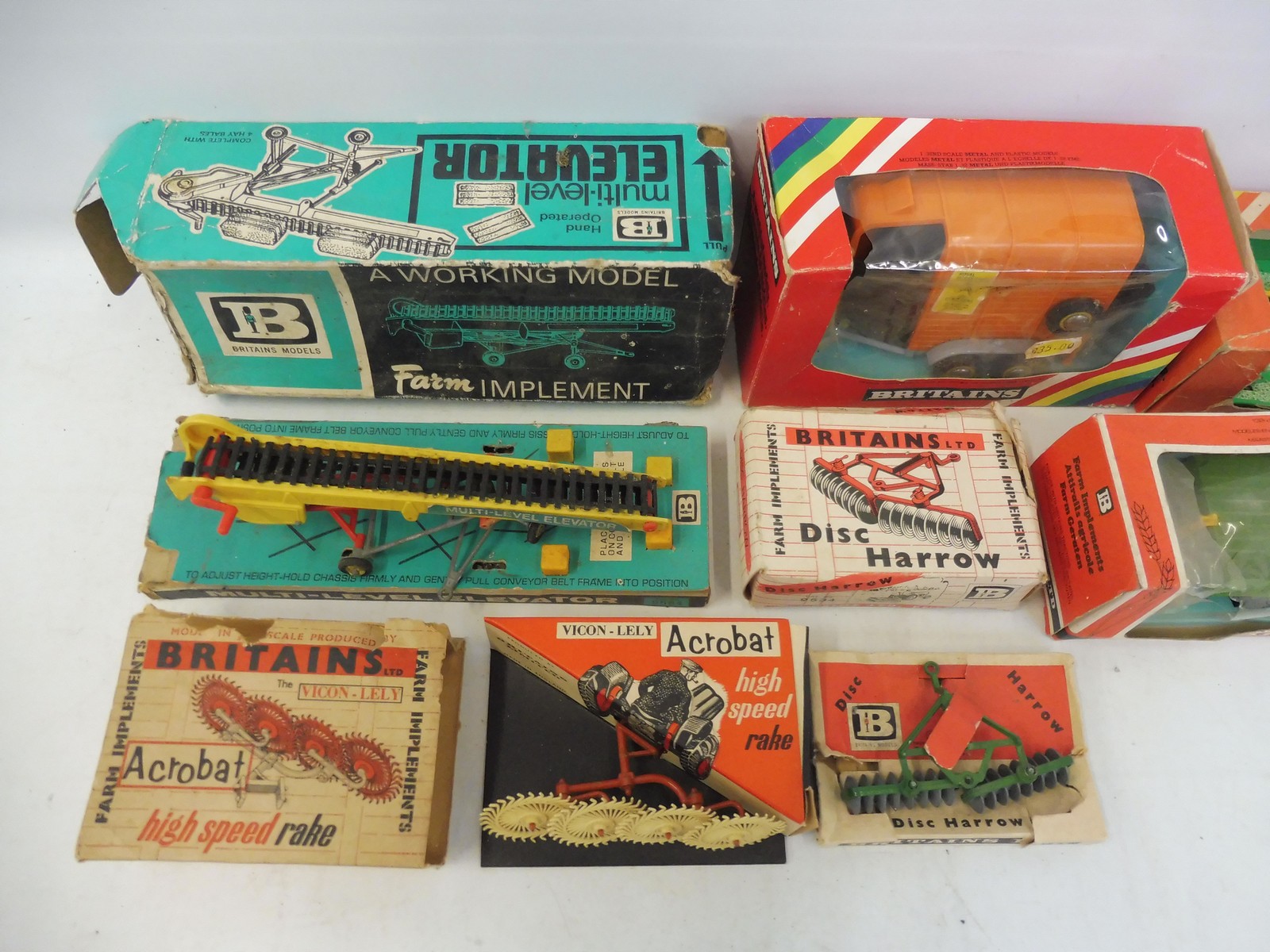 An assortment of Britains farm accessories from different eras, boxes in various conditions. - Image 2 of 3