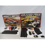 A boxed Scalextric Grand Prix set and a Mighty Metro set, both appear in excellent condition.