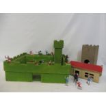 A handmade medieval fort, with a collection of plastic knights and horses.