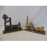 Two brass models, one of a coal mining scene, the other Stephenson's Rocket.