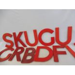 A quantity of plastic salvage letters and numbers, red colour.