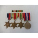 A WWII medal group comprising a 1939-45 Star, an Africa Star, an Italian Star and the 1939-45