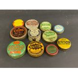 Eleven small ointment and other tins.