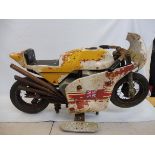 A juvenile motorcycle fairground ride for restoration, cafe racer style with metal handlebars and