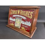 A rare counter top oak dispensing cabinet with sloping glass advertising front panel for George W.
