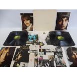 A The Beatles top loading White album, vinyl appears excellent, cover VG+, has four photos, inners