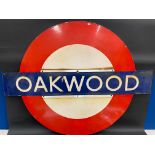 A London Underground railway station enamel sign for Oakwood, 52 1/2 x 40 3/4".