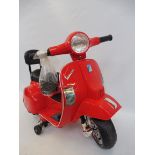 A battery operated model Vespa scooter.